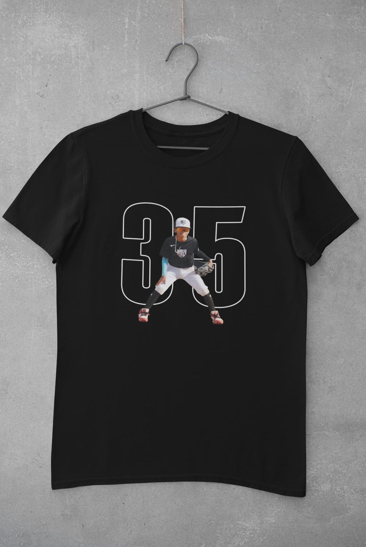Custom baseball mom player photo T-shirt mockup hanging on concrete wall