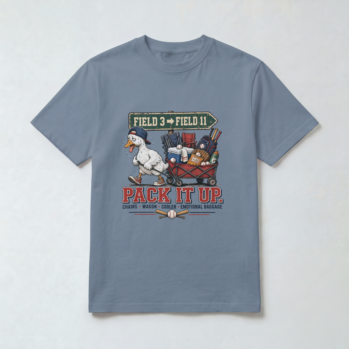 Blue Jean Comfort Colors 1717 travel baseball parent shirt with goose, gear wagon, Field 3 to Field 11 sign and Pack It Up graphic.