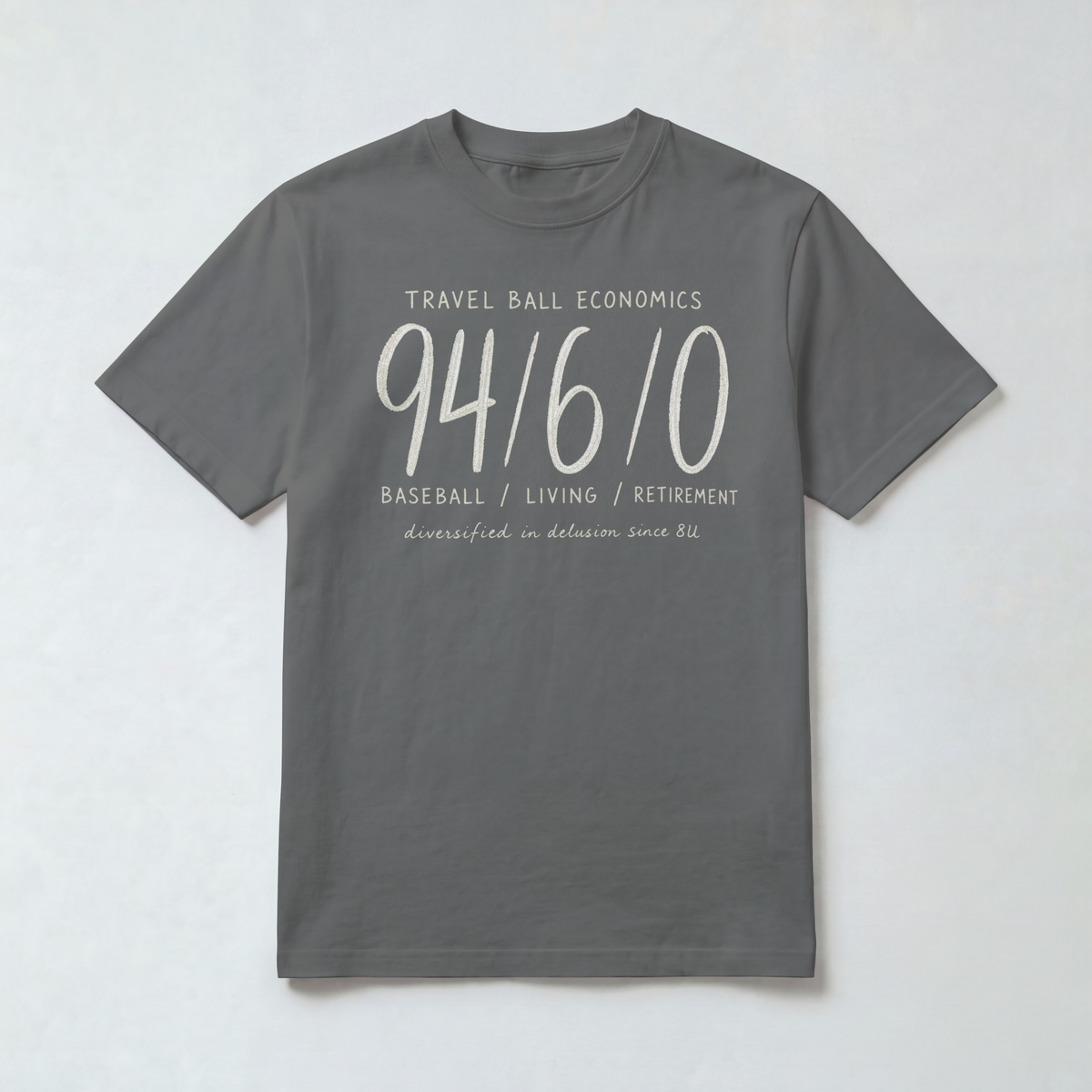 Funny travel baseball parent shirt in Pepper gray featuring the Travel Ball Economics 94/6/0 chalk-style design on a Comfort Colors 1717 tee.